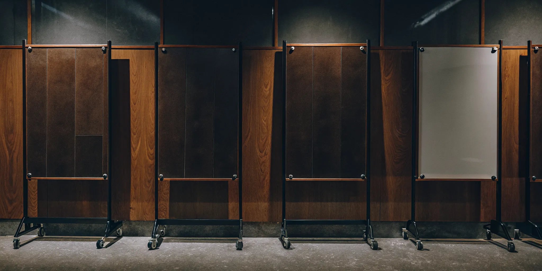 Mobile 72 x 48 whiteboards with wood and glass surfaces in a modern office.