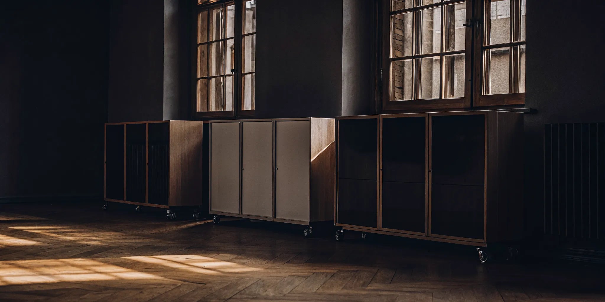 Mobile whiteboard storage unit with cabinets on wheels for an organized office or classroom.