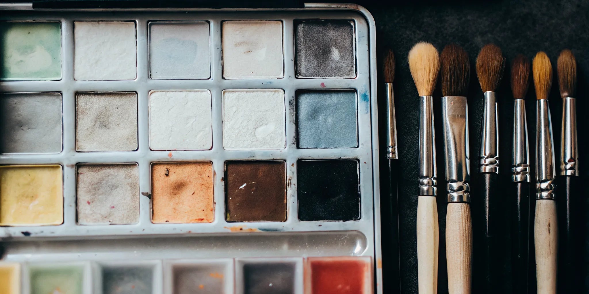 A professional watercolor paint set with high-pigment paints and brushes.